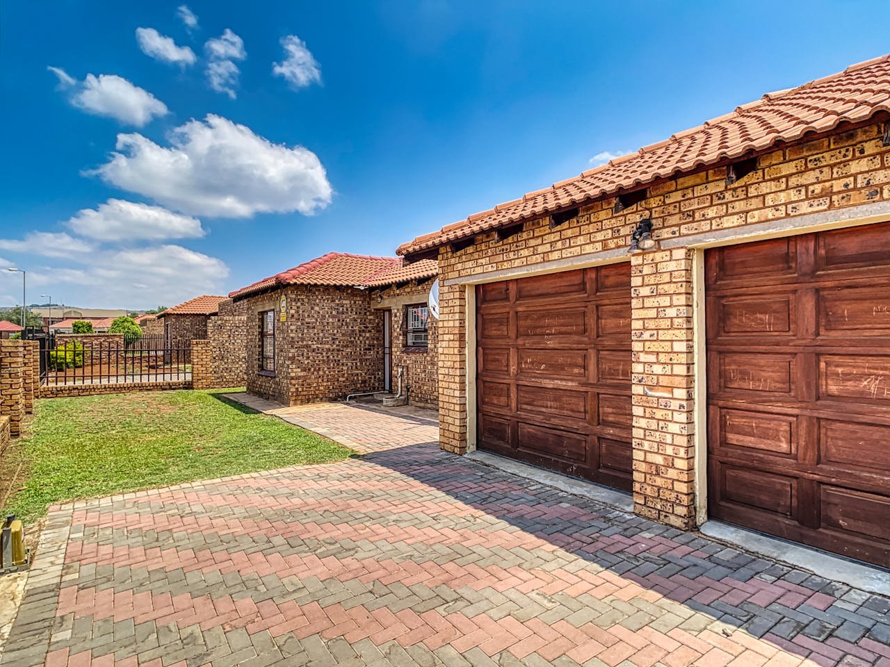 Beautiful brick home with double garage and paved driveway in Pretoria, South Africa.
